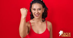 Eustress shown by strong happy woman with raised arm and fist on red background