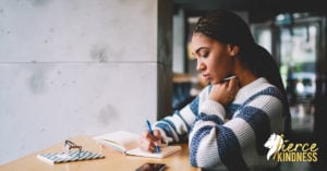 Woman Grieving Her Losses in Journal