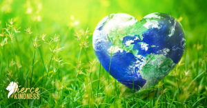Earth Day Planet as Heart Against Green Grass