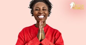 How to use Affirmations - woman in red sweater with big smile holding hands together