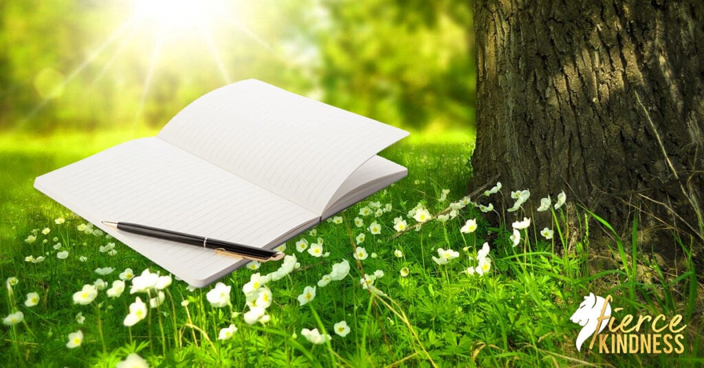 Spring Journal for prompts and pen on flowery background with tree