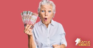 Woman looking shocked holding money in a fan on a pink background