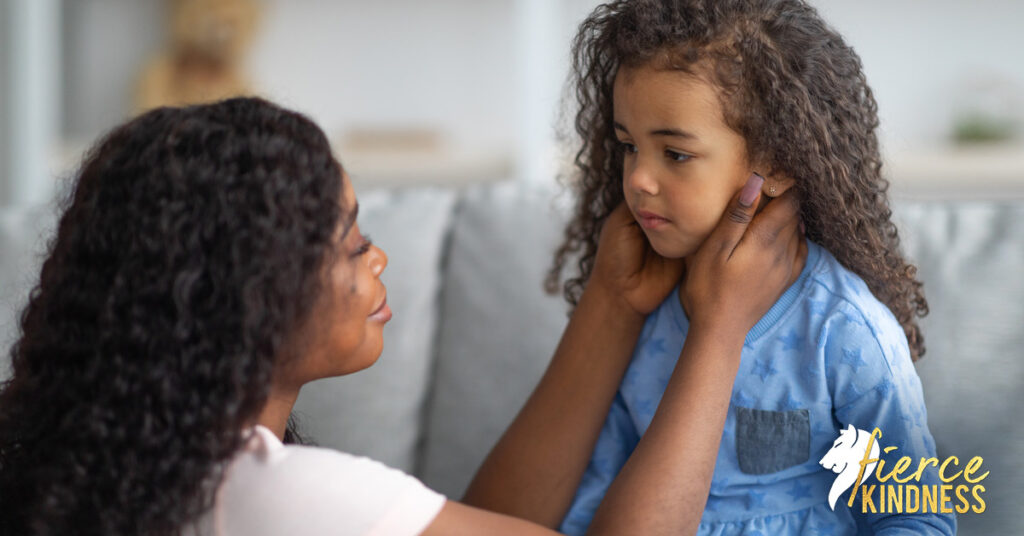 Mother kindly caring for scared inner critic (child) in living room