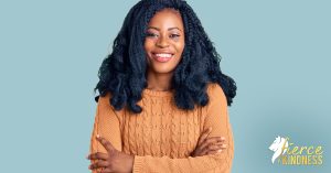 Happy Black woman in beige cable knit sweater with arms crossed smiling for are you living your values?