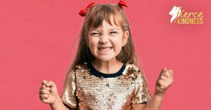Girl expressing joy in sequin top on pink background