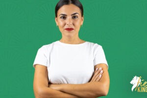 Smiling confident resilient woman against a green background