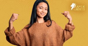 Strong Resilient Woman with arms raised in fists Against Golden Background with Rays Pattern