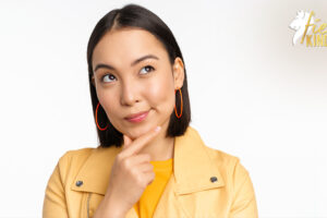 Woman pondering and looking up in yellow outfit