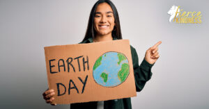 Woman holding Earth Day Sign pointing upwards