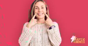 Woman forcing a smile with fingers to show being nice and am I a people pleaser on deep pink background