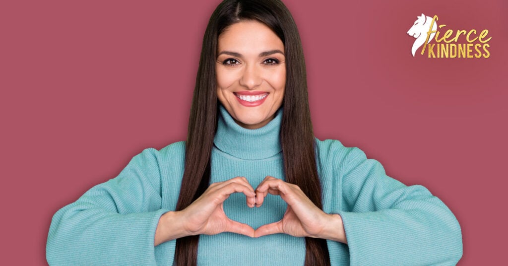 Strong woman smiling and making a heart shape with her hands