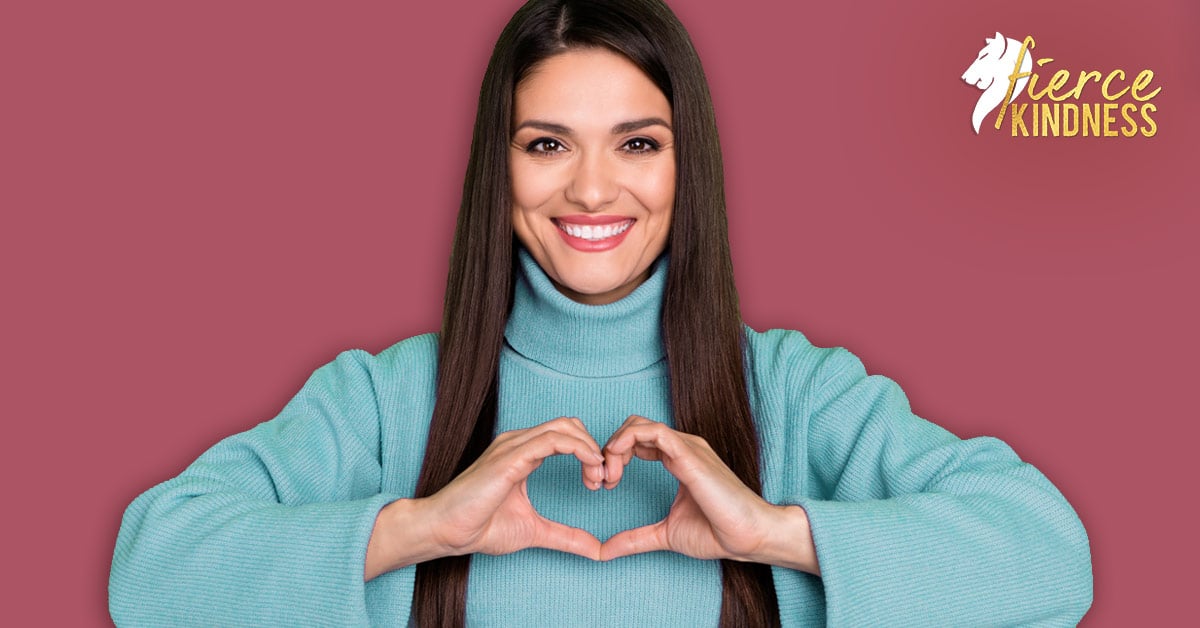 Strong woman smiling and making a heart shape with her hands