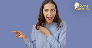 Young woman with comedic expression pointing at something